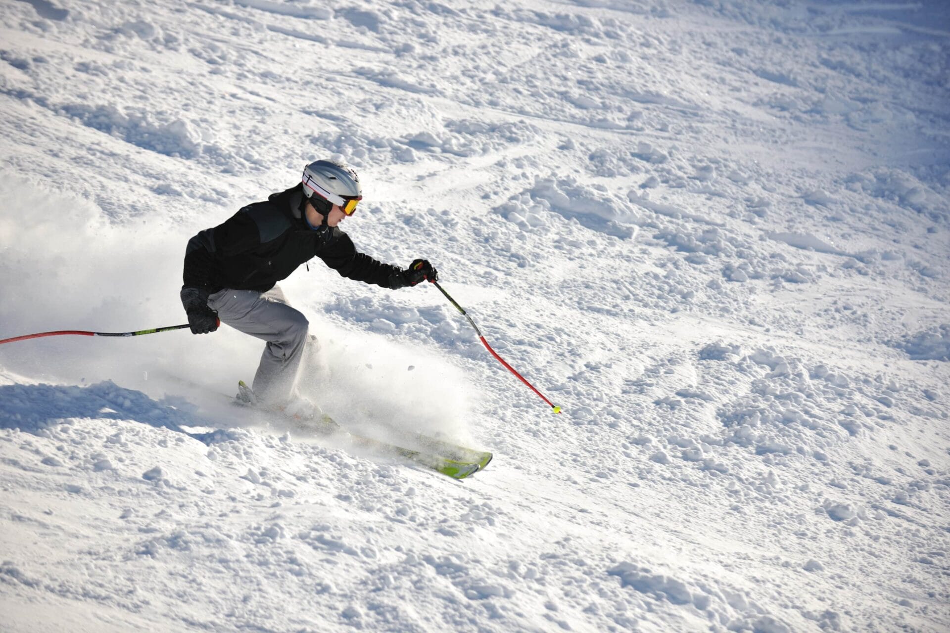 Tackle the ski slopes at four Québec City Resorts. This man is heading downhill on skis. 