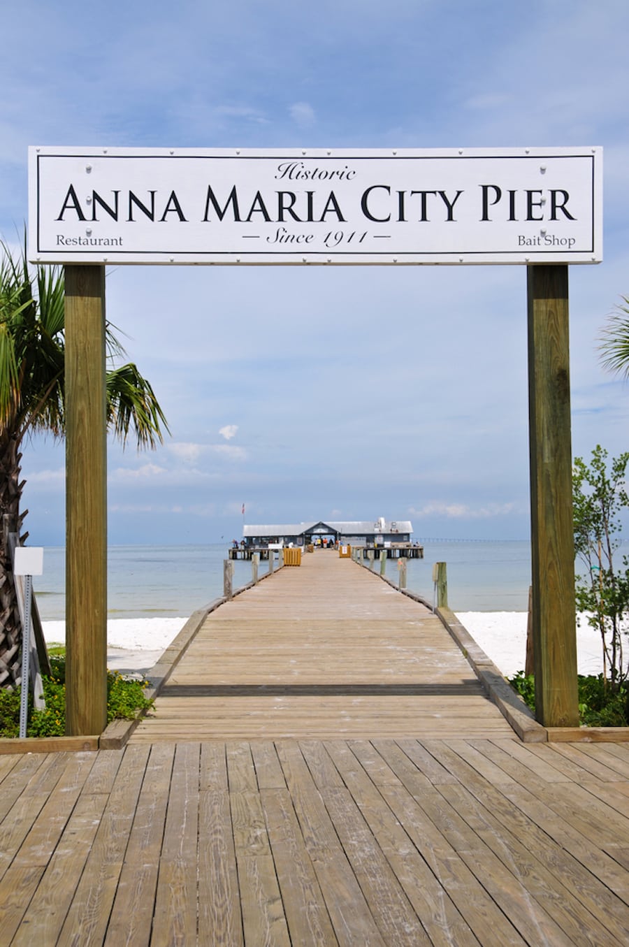 A sign showing the anna maria pier sign another great place to explore on your trip!