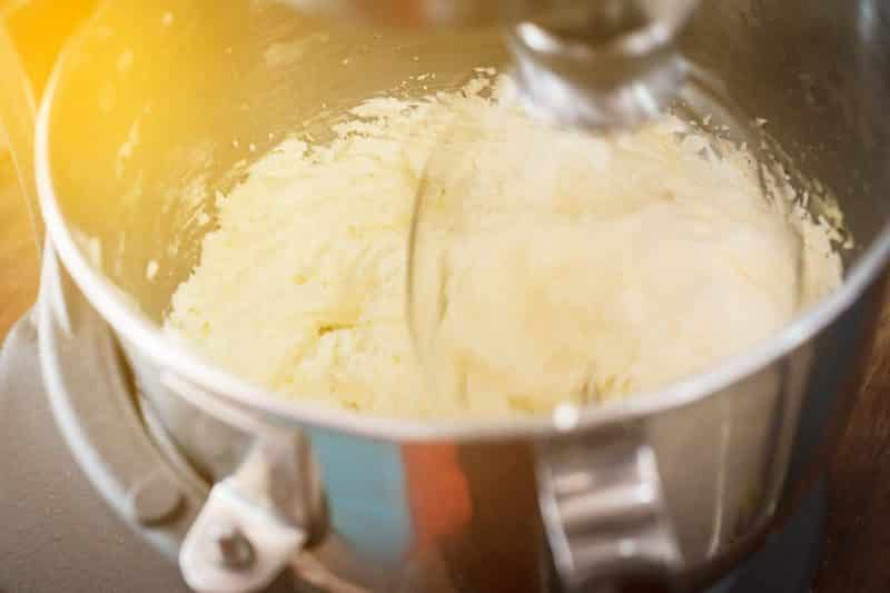 creaming butter and sugar in metal mixing bowl