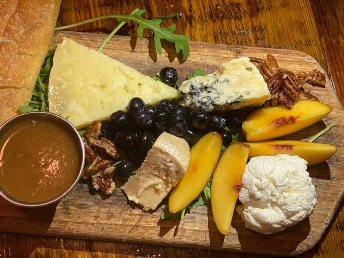 Charcuterie tray from The Floridian includes a variety of cheeses, nuts, honey, and fruits