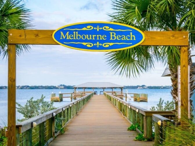 Melbourne Beach sign over beach walkway. Melbourne is one of the destinations that we love for the best romantic Florida getaways