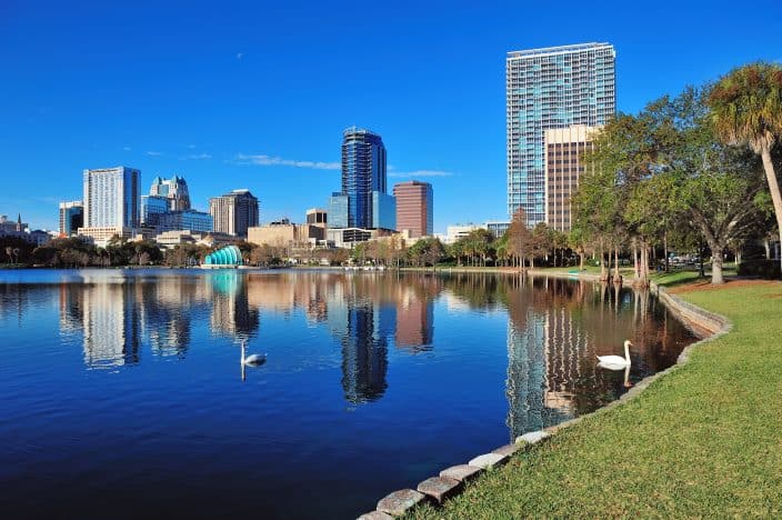 a lake in orlando with sky scrapers in the background