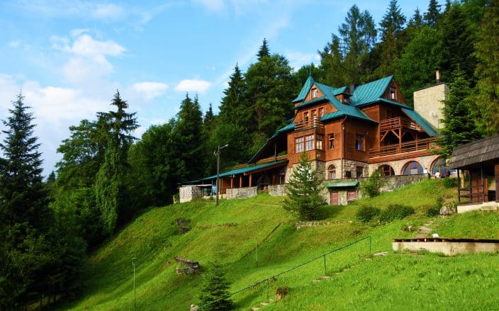 large cabin in the mountains with blue skies the perfect place to vacation