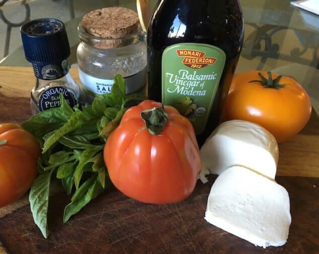caprese salad ingredient. Balsamic vinegar, tomatoes, mozzarella cheese, salt and pepper, and basil.