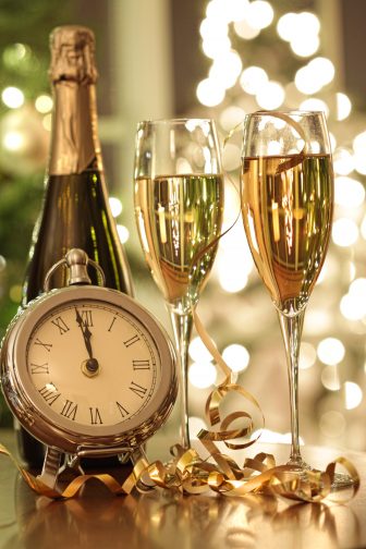 Champagne glasses and pocket watch ready to celebrate New Years Eve 
