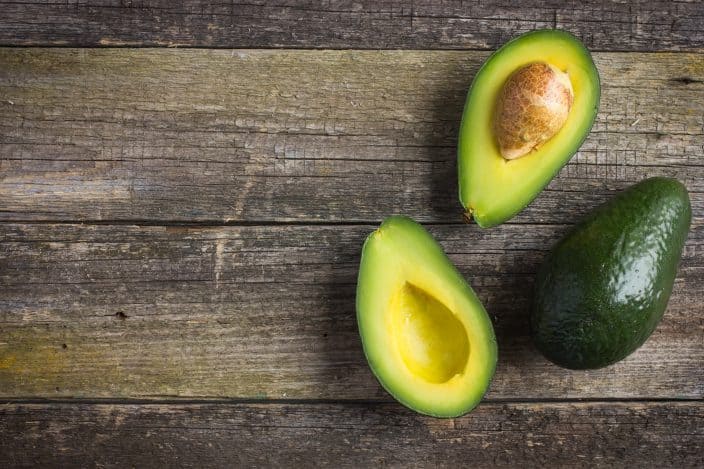 avocados on a wooden background