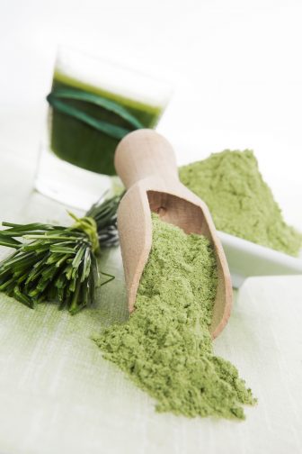 wheatgrass powder, fresh and juiced against a white background. A good addition to a smoothie