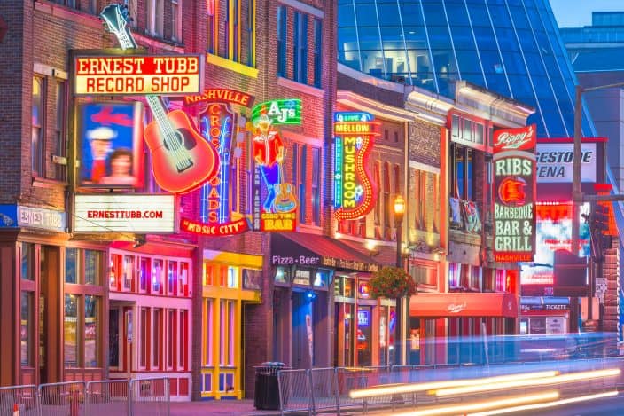 Honky-tonks lit up with neon lights on Lower Broadway in Nashville, Tennessee
