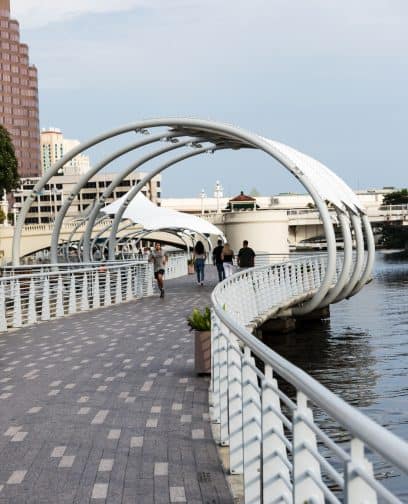 The Tampa Riverwalk with people running and walking