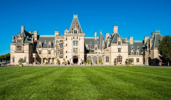 the Biltmore hotel and gardens, a large estate on green grass with blue skies, a popular attraction for a romantic spring getaway