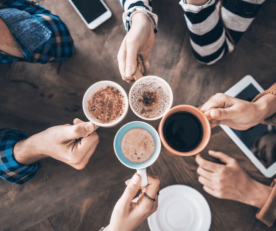 A bunch of friends showing their coffee cups next to each other. The perfect people for these gifts for the coffee addict.