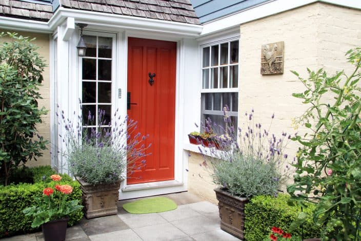 a house with a red front door and a garden