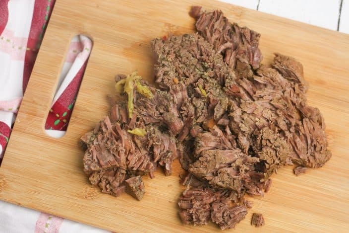 shredded beef on a cutting board