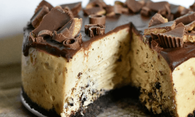 The best Reese's Peanut Butter Cheesecake with a slice cut out