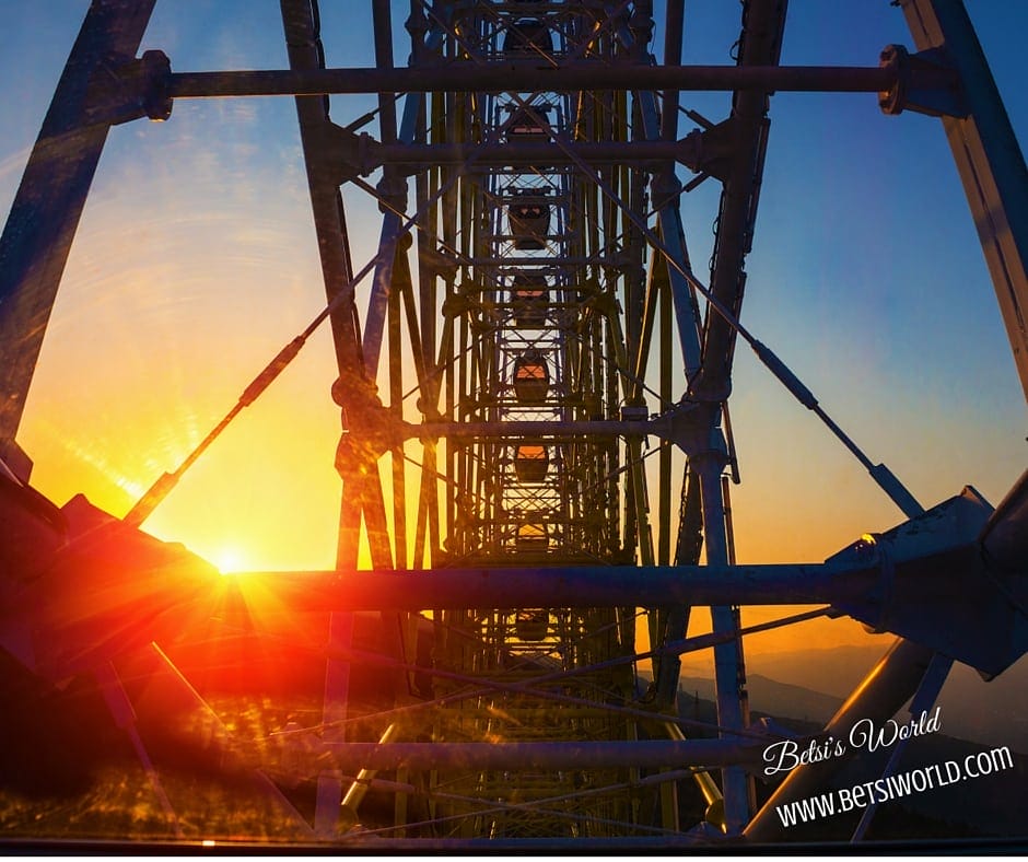 a rollercoaster track at sunset, a fun activity to do during your family vacation