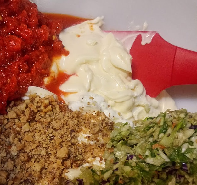 ingredients to make the best chicken salad. mayonnaise, red peppers, smoked almonds, greek yogurt, coleslaw and green onions