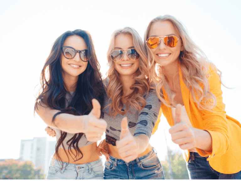 3 girls, wearing sunglasses with a thumbs up