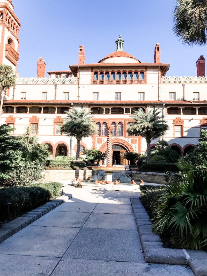 Flagler College in sunlight with the fountain in front, the perfect place to visit on your Florida weekend getaway. 