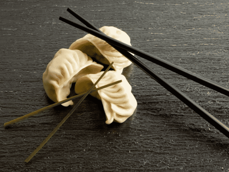 dimsum with chopsticks on wood table