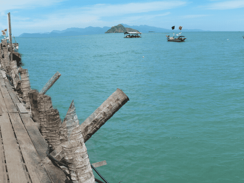 boats anchored with rustic pier