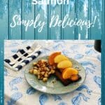 blue board background with plate of grilled teriyaki citrus honey salmon topped with citrus