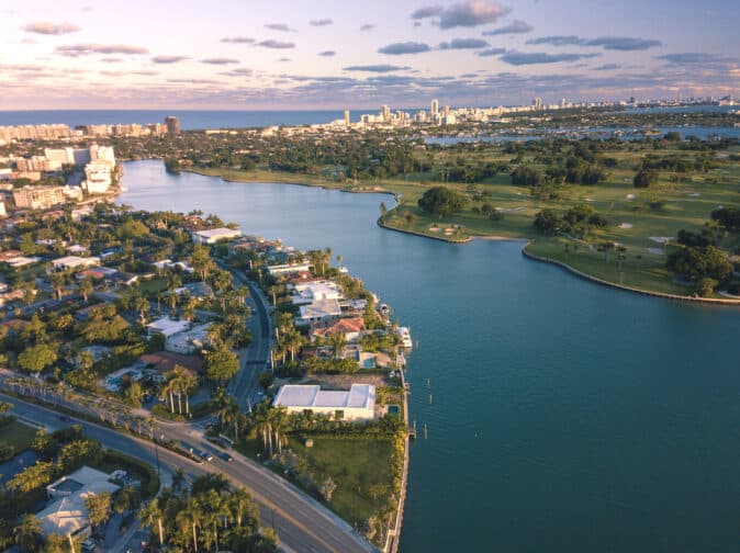 Aerial view of Sunny Isles Miami Beach during sunset with a view of the homes on the water, one of the best romantic getaways in Florida