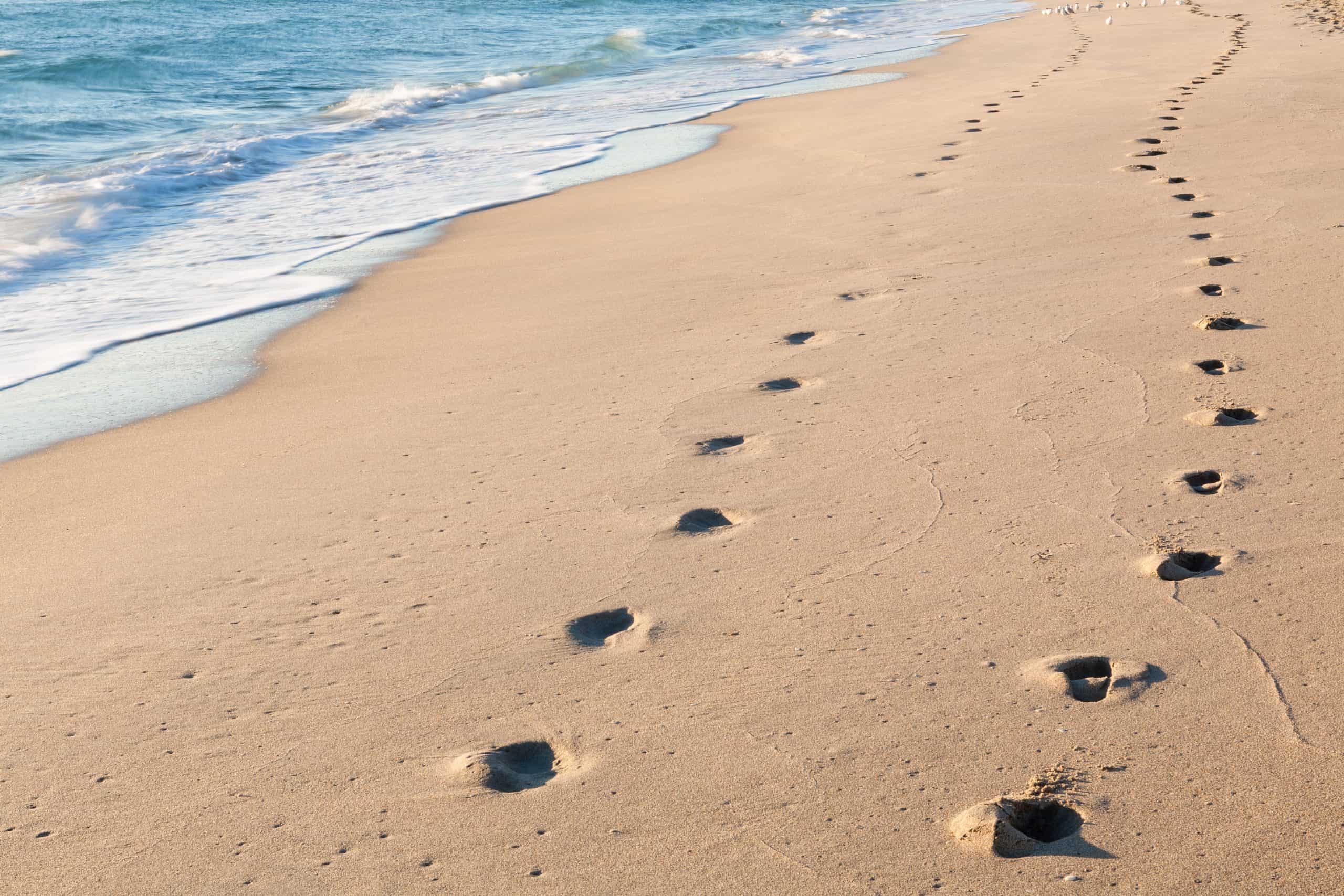 footprints on an empty beach