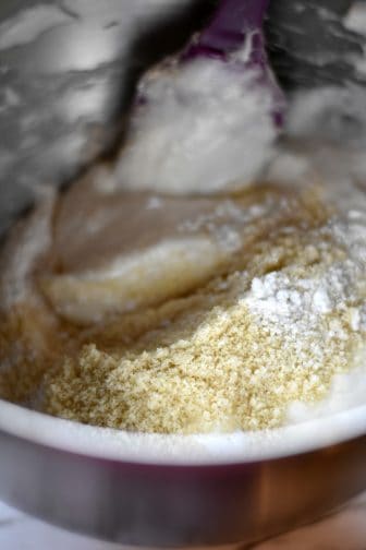 folding the dry mixture into the meringue to make Oreo macarons