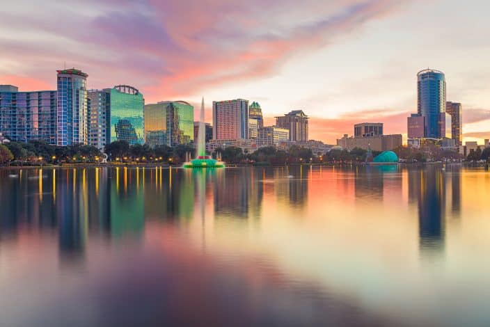 The Orlando skyline at sunset. A view looking out over the water, the perfect place for a romantic weekend getaway