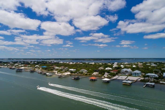 Pensacola coast line, aerial view with boats in the water and waterfront houses. The perfect place for a romantic getaway