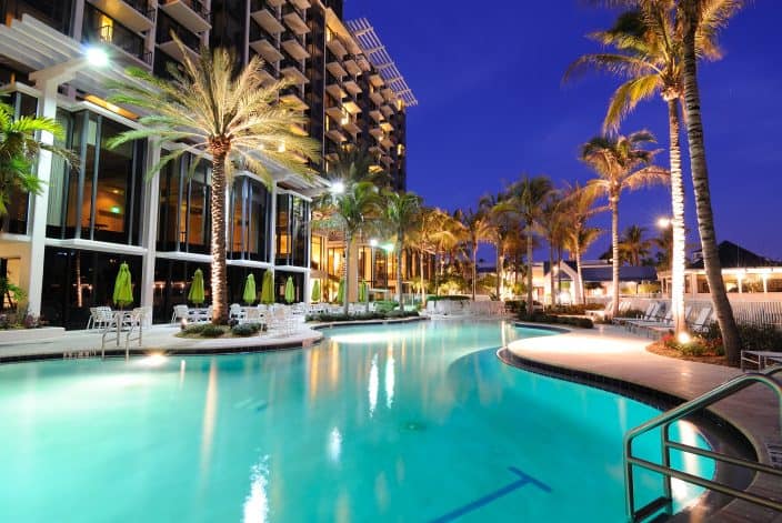 luxury hotel pool at night with palm trees