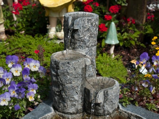 small stone fountains in the backyard as part of creating an oasis