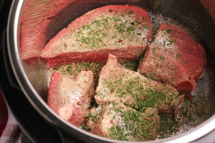 roast beef in a pot with seasoning to make instant pot italian beef