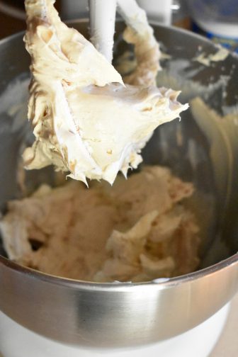 Cream cheese and peanut butter batter in a mixing bowl, the third step in creating a Reese's Peanut Butter cheesecake