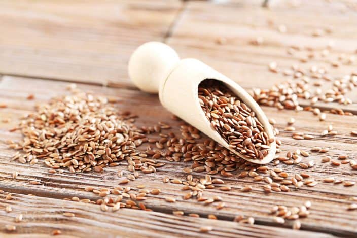 brown flax seeds on a wooden table