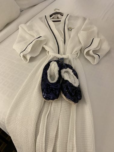 Plush white robe and blue sparkly slipper