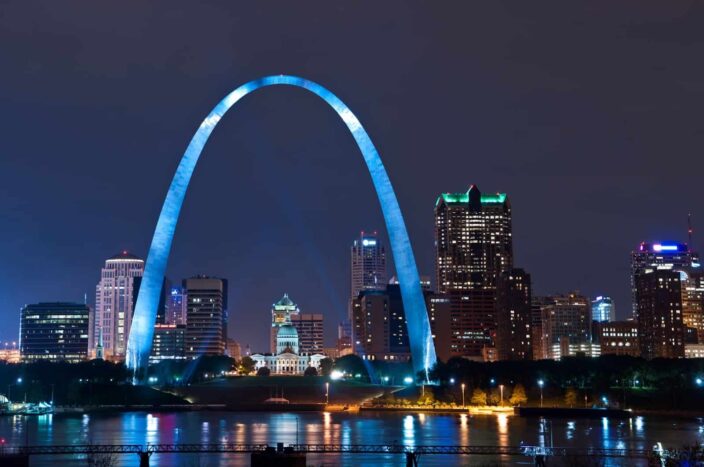 View of the glowing skyline, large arc sculpture, and skyscrapers in Bay St.Louis, Mississippi. 