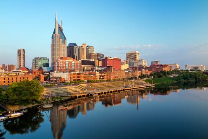 Nashville, Tennessee downtown skyline at Cumberland River, with blue skies and golden sunlight, a spring getaway destination
