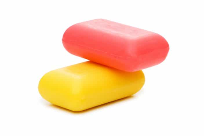 Stack of red and yellow soap bars isolated on a white background