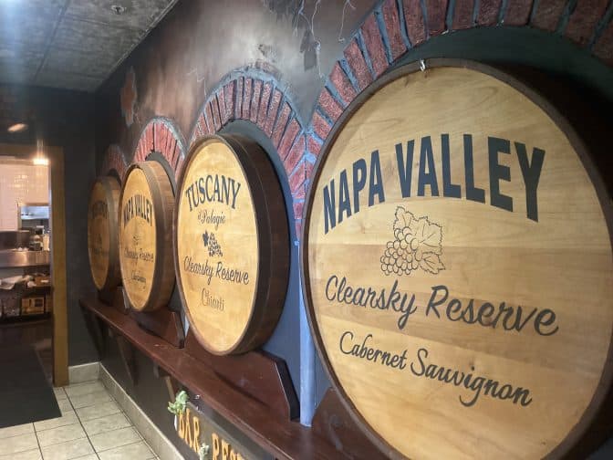 decorative wooden barrels of wine at Clear Sky restaurant on the walls with brick