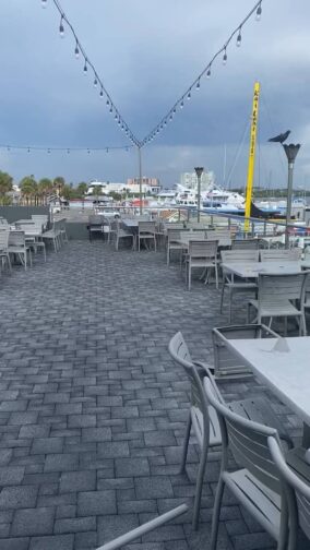 the rooftop at Marina Cantina with grey skies, tables and chairs, an example of things to do in Clearwater Beach