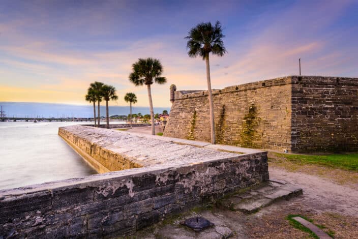 St. Augustine, Florida at the Castillo de San Marcos National Monument with pink, purple, and orange skies during sunset