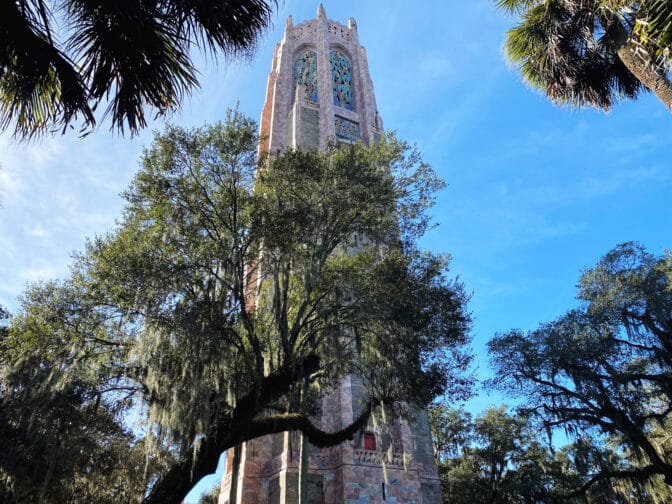 the tower at Bok Tower Gardens with blue skies and green landscape, an example of what to do in Kissimmee