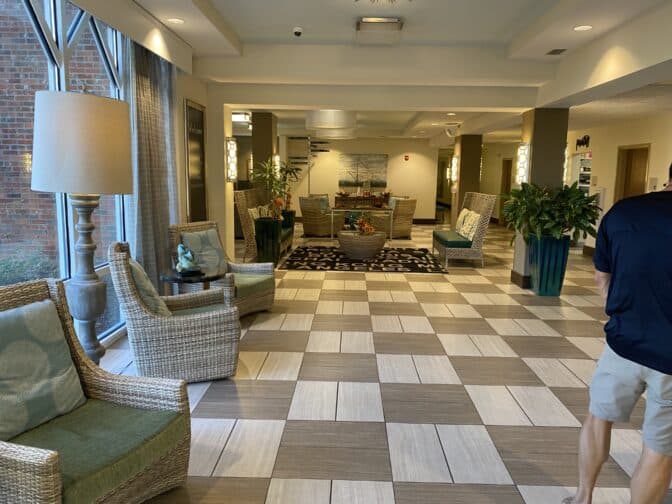 the lobby at the Sebastian Hotel with a relaxed atmosphere, rattan style chairs, plants, and tile flooring