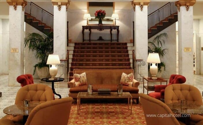 the inside of the capital hotel with orange and marble accents, a place to stay during your romantic getaway Arkansas