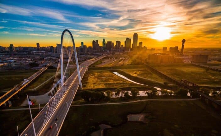 An aerial view of the city of Dallas, Texas with the Dallas bridge and cityscape the sunset in the background, excellent couples vacation in the south USA 