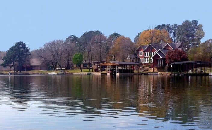 Lake Hamilton with a cottage on the edge of the lake, an example of where to stay during a romantic getaway Arkansas