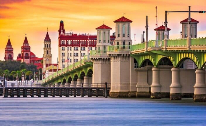 the St. Augustine bridge at sunset with red accents and blue water, a great option for a south USA couples vacation 