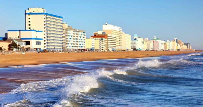 the shoreline of Virginia beach with bright blue skies, one of the best affordable romantic getaways
