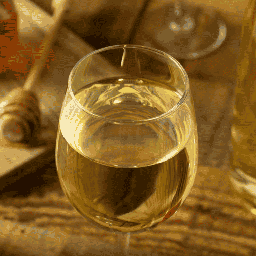 white wine in a glass on a wooden table